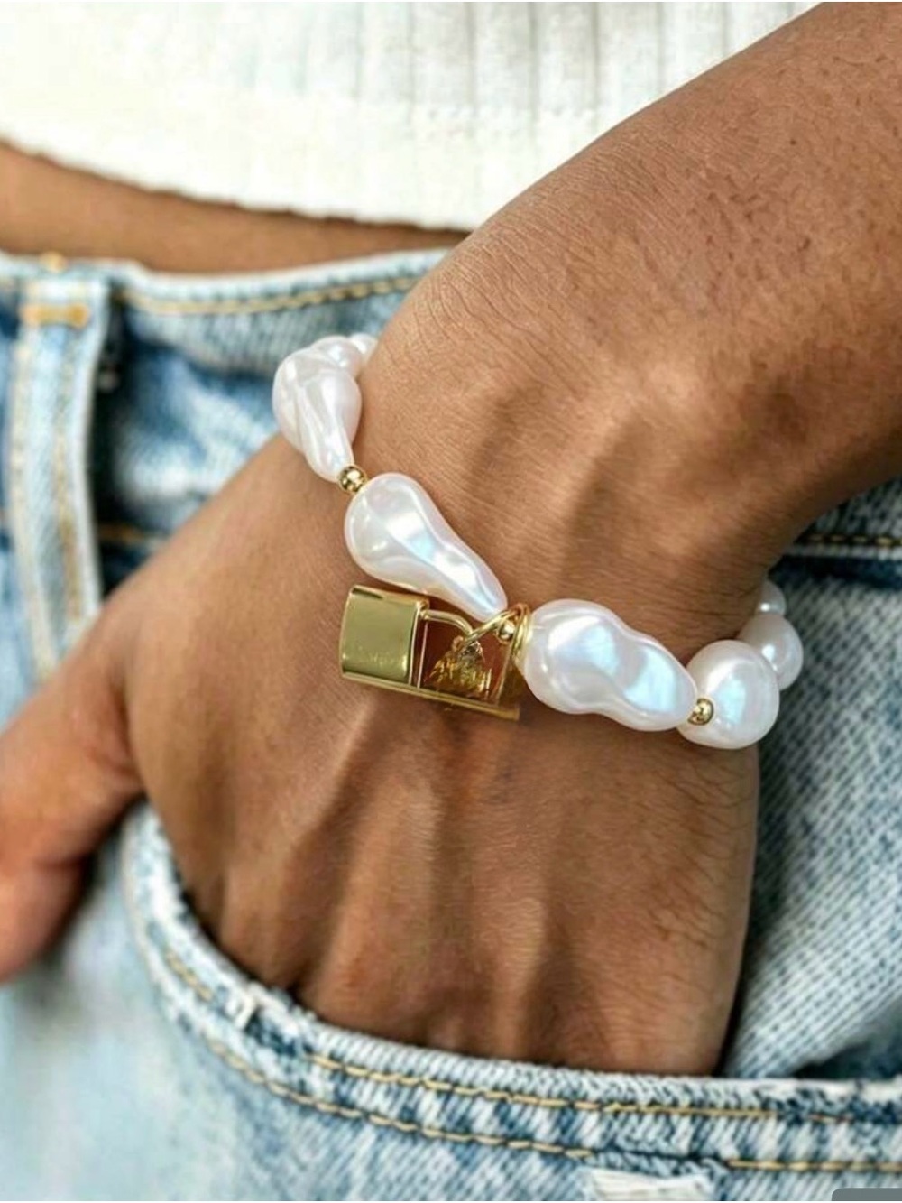 Faux pearl bracelet with a lock charm